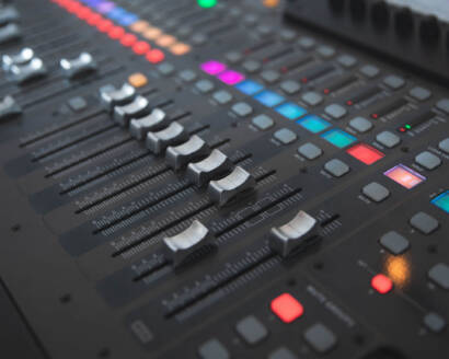 A close up of the buttons on an audio mixer.