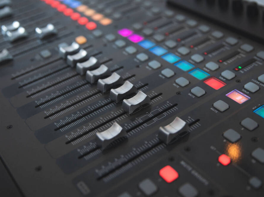 A close up of the buttons on an audio mixer.