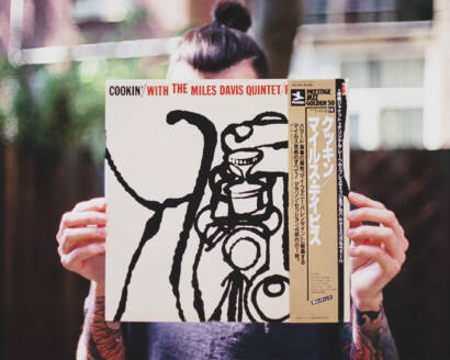 A person holding up an album cover of cookin ' with the blues band