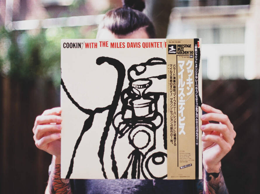 A person holding up an album cover of cookin ' with the blues band