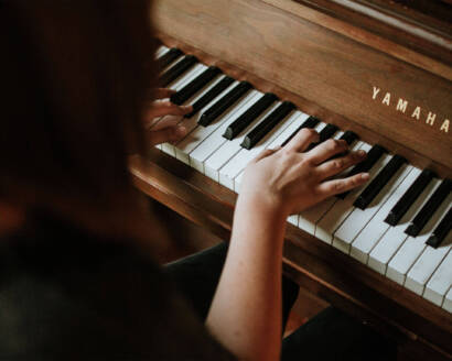 A person playing the piano with their hands