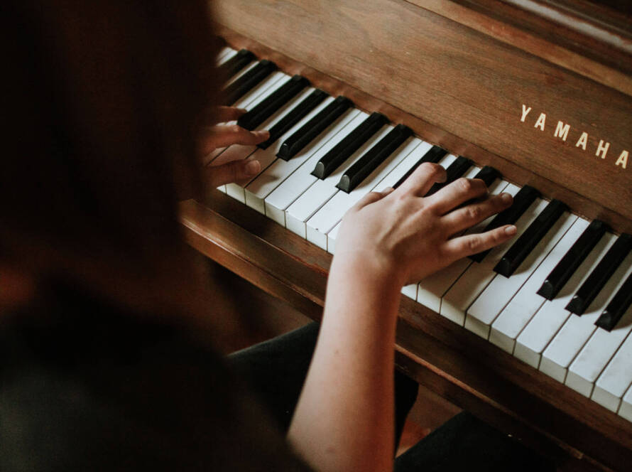 A person playing the piano with their hands