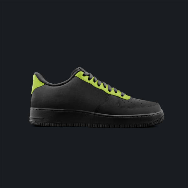 A pair of black and neon green sneakers.