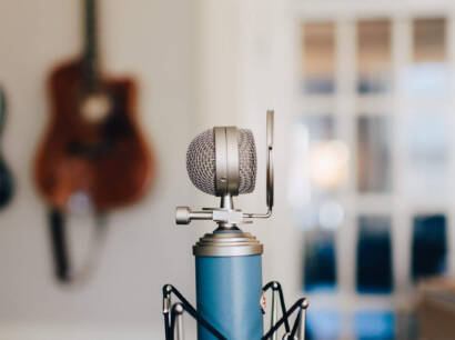 A microphone is sitting on top of a blue stand.