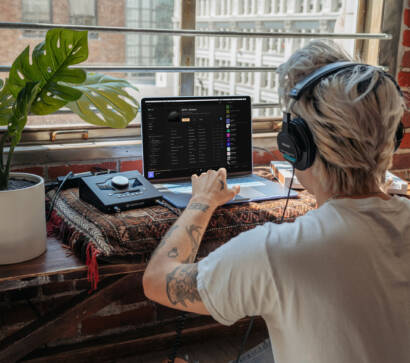 A person with headphones on sitting at a table