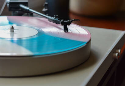 A record player with the lid open on top of it.