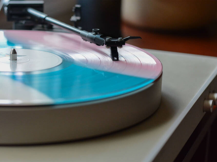 A record player with the lid open on top of it.