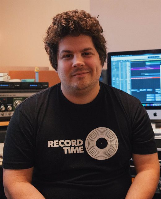A man in front of a computer screen.